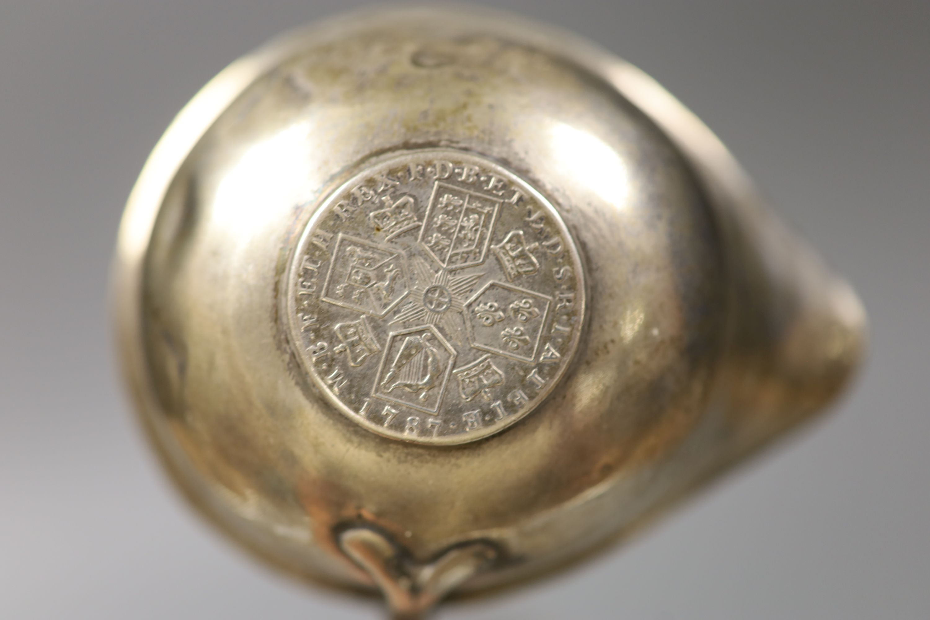 A George III silver cream jug, London, 1802 (a.f.)9.5cm and a 19th century white metal toddy ladle, 35cm.